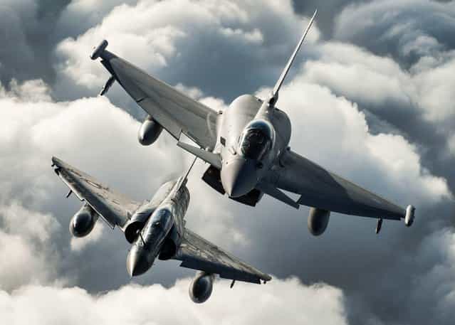 Ministrey of Defence undated handout photo of a RAF Typhoon of 1(F) Sqn and a French Air Force Mirage 2000N (bottom) practice their formation flying skills as part of Ex Capable Eagle over the skies of RAF Leeming in North Yorkshire, on October 15, 2013. (Photo by Sgt Ralph Merry ABIPP RAF/PA Wire)