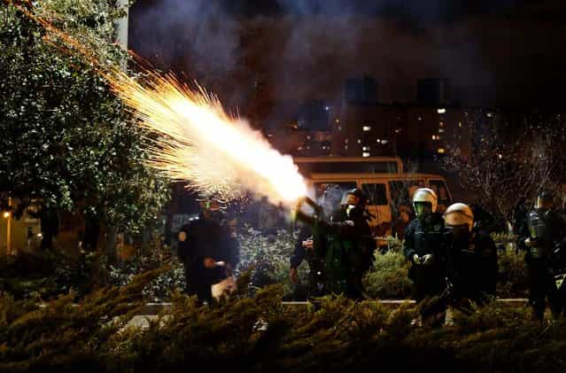 Police fire tear gas to disperse university students demonstrating against reconstruction plans that includes a part of their campus in Ankara, Turkey, on Oktober 19, 2013. The municipality plan opposed by the students involves building a road across the Middle East Technical University campus and uprooting a large number of trees in the area. (Photo by Umit Bektas/Reuters)