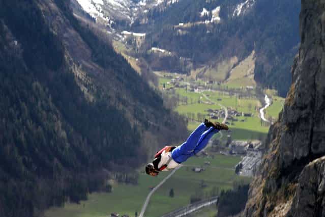 Daredevils took part in the jump from Mushroom Cliff on the north face of the Eiger in Switzerland as part of a base jumping class, on Oktober 16, 2013. (Photo by Caters News)