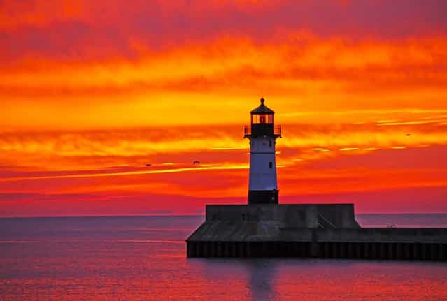 The sky above Lake Superior is filled with color at dawn as seen from Canal Park in Duluth, Minn, on Oktober 17, 2013. (Photo by Andrew Krueger/The Duluth News-Tribune)
