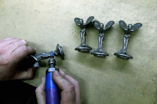 Worker Barry Smith finishes some of the iconic mascots. (Photo by Stefan Wermuth/Reuters)