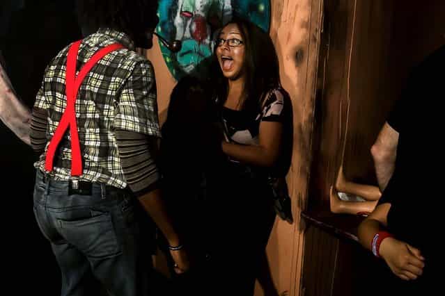 Fright Nights attendees make a turn through one of four haunted houses at this year's spooking season setup at the South Florida Fairgrounds. This house is named The Smiths and was created by Craig McInnis.