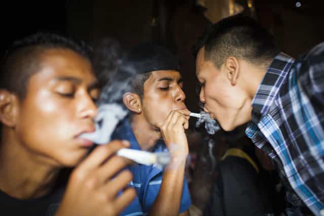 Mara Salvatrucha (MS) gang members smoke marijuana in the Las Victorias district of San Salvador. In March 2012, the two largest gangs in El Salvador – the Mara Salvatrucha (MS) and the Barrio 18 (M18) – agreed on a truce following secret negotiations between gang leaders in prison which were mediated by a bishop and a former rebel leader. It is unclear whether the decision was the idea of the gangs themselves or whether they were encouraged by the government. The murder and kidnapping rate has fallen significantly since the beginning of the truce but it remains unclear how long the truce will hold. (Photo by Adam Hinton)