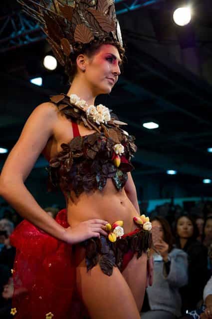 London, United Kingdom. 18th October 2013. A model showcases a chocolate dress at the London Chocolat Fashion show 2013. Salon du Chocolat, the world's largest chocolate show comes to London. This spectacular finish to a wonderful line up of Chocolate Week activities takes place from 18th-20th October at National Hall, Olympia. (Photo by Anastasia Mishchenko/Demotix Photojournalist)