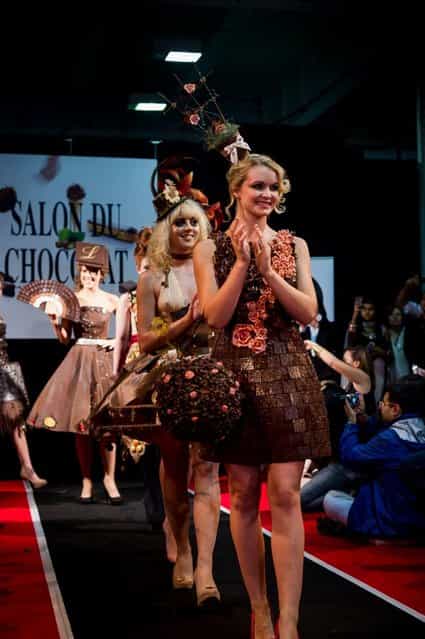 London, United Kingdom. 18th October 2013. Models showcases a chocolate dress at the London Chocolat Fashion show 2013. Salon du Chocolat, the world's largest chocolate show comes to London. This spectacular finish to a wonderful line up of Chocolate Week activities takes place from 18th-20th October at National Hall, Olympia. (Photo by Anastasia Mishchenko/Demotix Photojournalist)