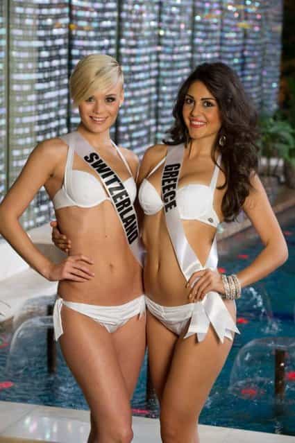 A handout picture taken on October 23, 2013 and provided by Miss Universe 2013 shows Miss Universe 2013 contestants, Miss Switzerland 2013, Dominique Rinderknecht, and Miss Greece 2013, Anastasia Sidiropoulou, posing in their 2014 YAMAMAY FOR MISS UNIVERSE swimwear collection at the Crowne Plaza Moscow World Trade Centre, during the preparation for the beauty contest in Moscow. Miss Universe 2013 contestants arrived in the Russian capital Moscow to be crowned at the pageant final show on November 9. (Photo by Richard Salyer/AFP Photo/Miss Universe Organization)