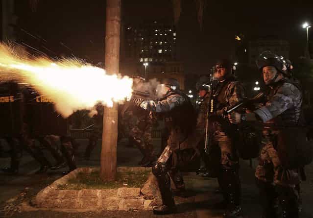 Military police fire tear gas at demonstrators from the group called Black Bloc, during a protest against the bad conditions of public transport, in Sao Paulo, Brazil, on Oktober 25, 2013. (Photo by Nacho Doce/Reuters)