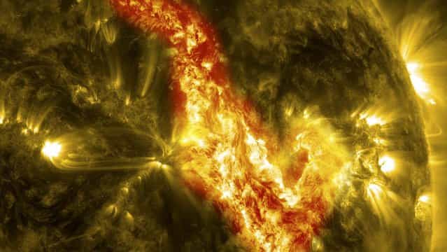 In this image released today, NASA's Solar Dynamics Observatory captured the magnetic filament of solar material erupting as a 200,000-mile-long filament ripped through the sun's atmosphere, leaving behind what looks like a canyon of fire during its eruption September 29 – 30. The glowing canyon traces the channel where magnetic fields held the filament aloft before the explosion. In reality, the sun is not made of fire, but of something called plasma: particles so hot that their electrons have boiled off, creating a charged gas that is interwoven with magnetic fields. (Photo by NASA/Solar Dynamics Observatory)