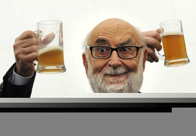 Belgian physicist Francois Englert holds a mug of beer after a news conference in Oviedo, Spain, on Oktober 24, 2013. Englert, U.S. professor Peter Higgs and the European Organization for Nuclear Research will receive the 2013 Principe de Asturias Award for Technical and Scientific Research in a ceremony on October 25. (Photo by Eloy Alonso/Reuters)