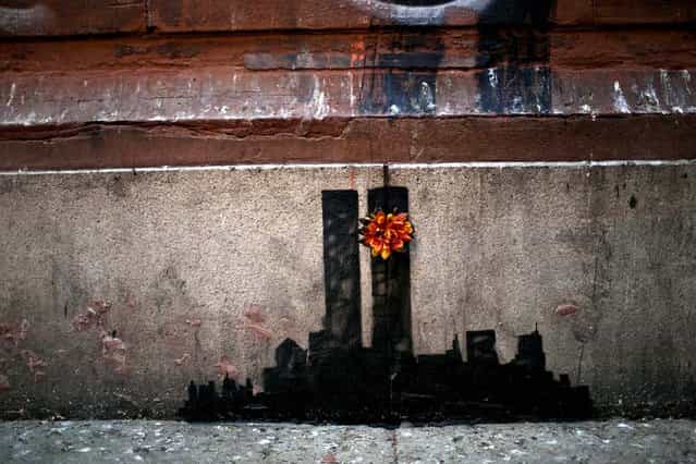 A work of art by Banksy commemorating the 9/11 attacks is seen on a wall in lower Manhattan, October 15, 2013. (Photo by Kirsten Luce/The New York Times)