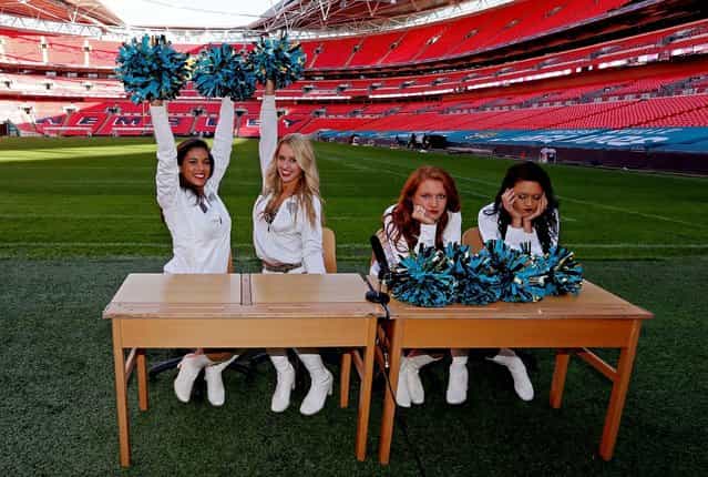 Kayla and Jessica from the Jacksonville Jaguars cheerleaders celebrate beating fellow cheerleaders Talitha and Caitlin, having swapped their pom poms for pencils to be tested on their knowledge of Wembley Stadium ahead of the game against the San Francisco 49ers this Sunday. The girls, from left to right, Kayla, Jessica, Talitha and Caitlin. (Photo by Scott Heavey/The FA)