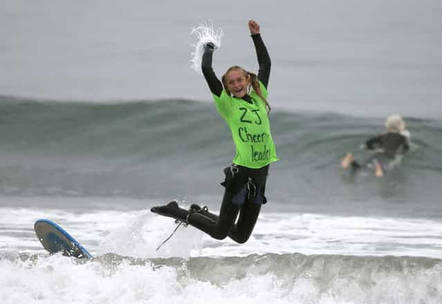 Vienna Werner, 15, competes dressed as a cheerleader in the ZJ Boarding House Halloween Surf Contest in Santa Monica, California October 26, 2013. (Photo by Lucy Nicholson/Reuters)
