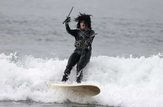 Heather Blanda, 32, competes dressed as [Edward Scissorhands] in the ZJ Boarding House Halloween Surf Contest in Santa Monica, California October 26, 2013. (Photo by Lucy Nicholson/Reuters)