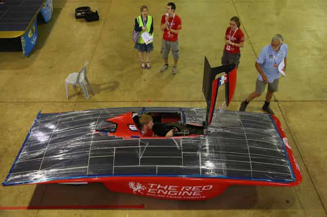 A driver sits inside of The RED Engine from the Solar Team Twente, University of Twente and Saxion in the Netherlands as the solar car is examined as cars are presented to the scrutineers for inspection and confirmation of their regulatory compliance and structural integrity on October 2, 2013 in Darwin, Australia. (Photo by Scott Barbour/Getty Images for the World Solar Challenge)