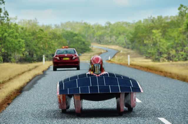 A handout image of the Red Engine Team obtained on 04 October 2013 shows the Red Engine solar car during a test drive on Cox Penninsula Road outside Darwin, Australia, 16 September 2013. The Dutch vehicle is competing in the World Solar Challenge, driving from Darwin to Adelaide starting on 06 October 2013. (Photo by Joost Van Baars/EPA/Red Engine Team)