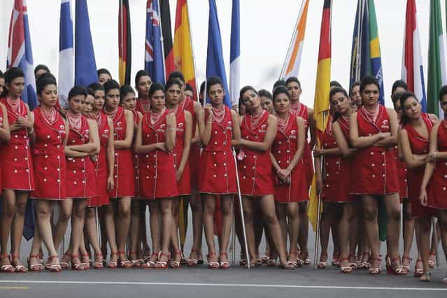 Pit girls rehearse on the eve of the Indian F1 Grand Prix at the Buddh International Circuit in Greater Noida, on the outskirts of New Delhi, October 26, 2013. (Photo by Anindito Mukherjee/Reuters)