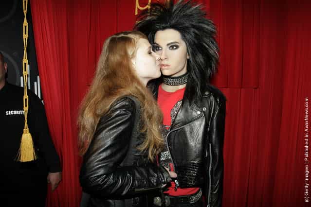 A Tokio Hotel fan poses with Bill Kaulitz wax figure at Madame Tussauds