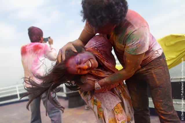 Revelers celebrate the Indian festival of Holi on a boat cruise around part of Manhattan