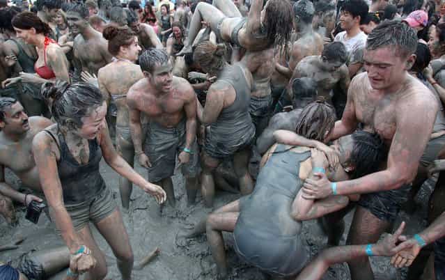 Festival goers plays in mud during the 15th Annual Boryeong Mud Festival at Daecheon beach in Boryeong, southwest of Seoul