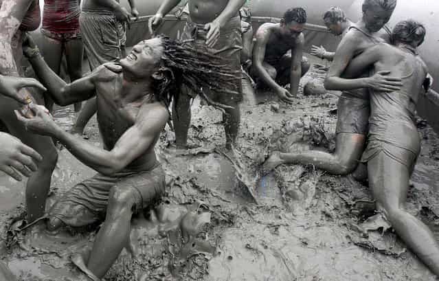Tourists enjoy themselves at the 15th annual mud festival on Daecheon Beach in Boryeong, South Korea