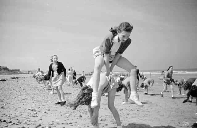 Pupils enjoying games on the beach during a working break at the residential branch of their Wakefield school by the seaside in Hornsea. 7th August 1948. (Photo by Haywood Magee)