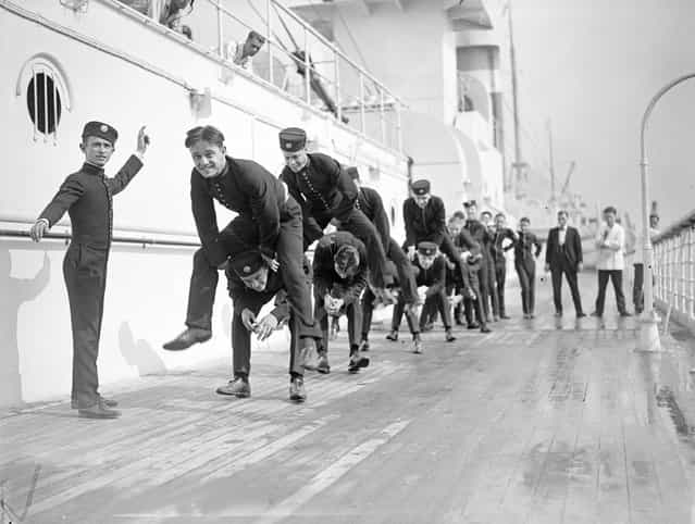 Young bellhops playing leapfrog on the sun deck of US liner Leviathan (former Hamburg America line vessel Vaterland), on arrival at Southampton, 1923. (Photo by A. R. Coster)