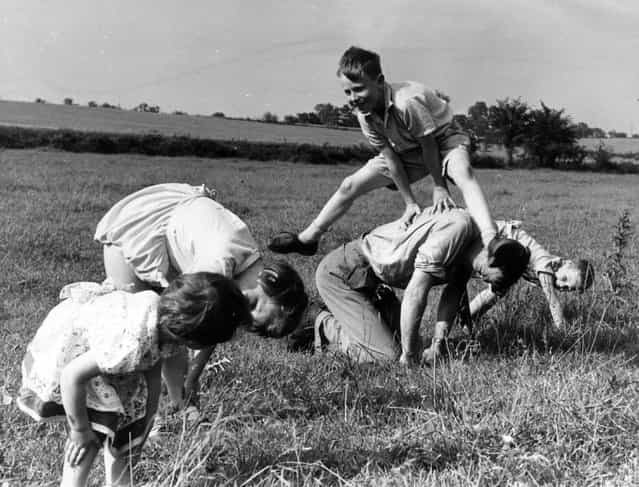 A game of leap-frog in a field, May 1955. (Photo by Charles Hewitt)