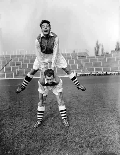 Arsenal's new signings from Leyton Orient, Vic Groves (jumping) and Stan Charlton, enjoying their first day of trraining at Arsenal's Highbury Stadium in North London, 8th November 1955. (Photo by L. Blandford)