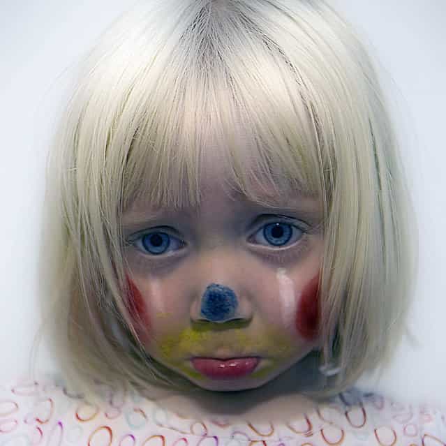 Sad Clown. [God I love face painting day at daycare. Today Frankie came home as a clown. Which should be a happy thing but I always think of clowns as sad so I immediately said [time to take pictures" and "make your sad face]. She takes direction so well for an almost three year old. Later, we were in the back yard with the dogs and Colonel Mustard had an apple and jumped on the lawn chair to eat it. Frankie turns to me and says [We need a picture of this]. That's my girl!] – Rich. (Photo by Rich)