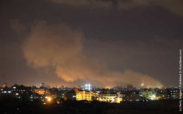 A plume of smoke rises above Gaza City as Israeli air strikes hit on August 18, 2011 in Gaza City, Gaza