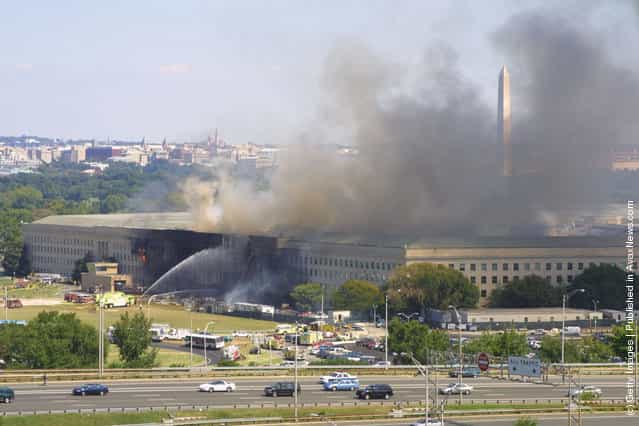 Smoke comes out from the west wing of the Pentagon building September 11, 2001 in Arlington, Va., after a plane crashed into the building and set off a huge explosion