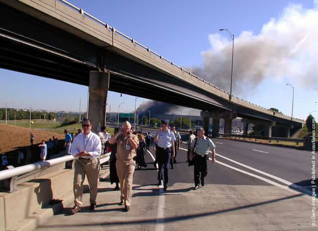 Military personnel move down highway I-395 while evacuating the Pentagon September 11, 2001