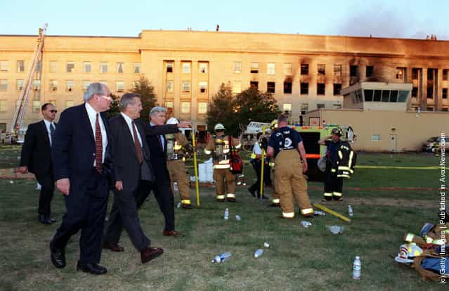 U.S. Secretary of Defense Donald H. Rumsfeld (C) leads Sen. Carl Levin (L), D-Mich., and Sen. John Warner (R), R-Va., to the crash scene at the Pentagon heliport September 11, 2001