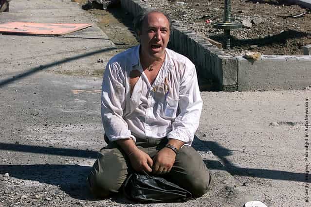 A survivor sits outside the World Trade Center after two planes hit the building September 11, 2001 in New York City