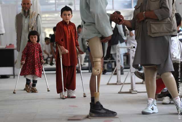 Afghan war amputees and children practice walking at the International Committee of the Red Cross (ICRC), orthopedic center