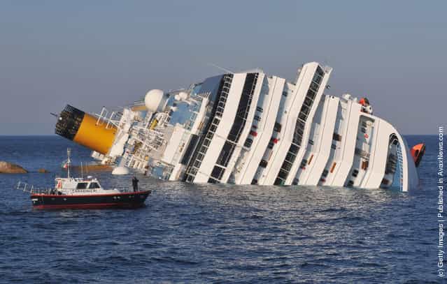 The cruise ship Costa Concordia lies stricken off the shore of the island of Giglio in Giglio Porto, Italy