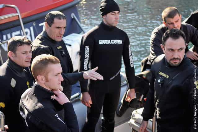 Rescuers Carabinieri of GIS work on the cruise ship Costa Concordia as it lies stricken off the shore of the island of Giglio