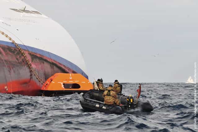 Rescue teams approach the Costa Concordia as it lies stricken off the shore of the island of Giglio