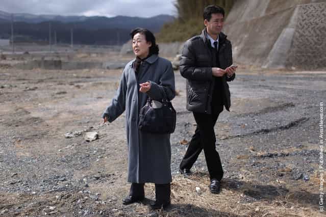 Setsuko Kinno, 72 (L) and son Yoshinori Kinno, 41 revist the site of her house on March 11, 2012 in Rikuzentakata, Japan