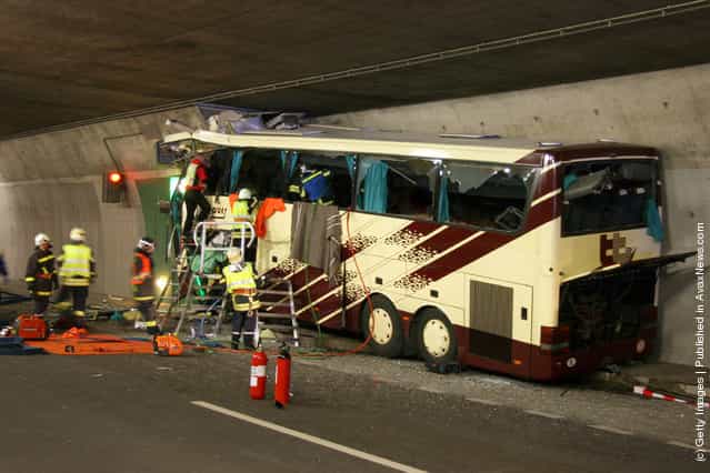 In this handout image provided by the Police of Swiss canton Valais the wreckage of a bus is seen after it crashed inside a motorway tunnel on March 13, 2012 in Sierre, Switzerland
