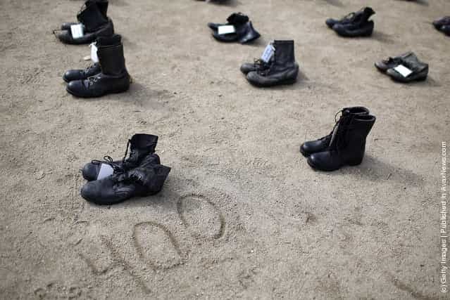 ows of combat boots that are part of the Eyes Wide Open exhibit are displayed in front of San Francisco City Hall