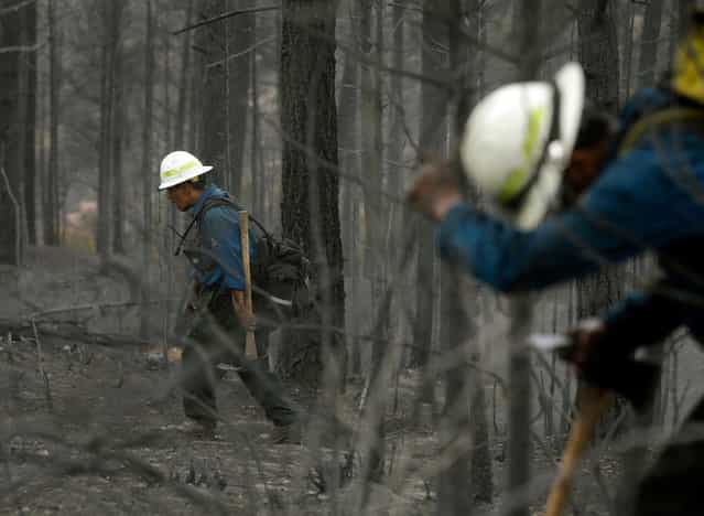 Members of Bighorn 209, a hand crew from the Crow Agency in Montana check for hot spots on the Waldo Canyon Fire west of Colorado Springs, on June 29, 2012. (AP Photo/Chris Carlson)