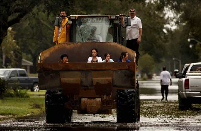 The Nguyen family is evacuated from their home in La Place, Louisiana, on Thursday. (Photo by Carolyn Cole/Los Angeles Times/MCT)