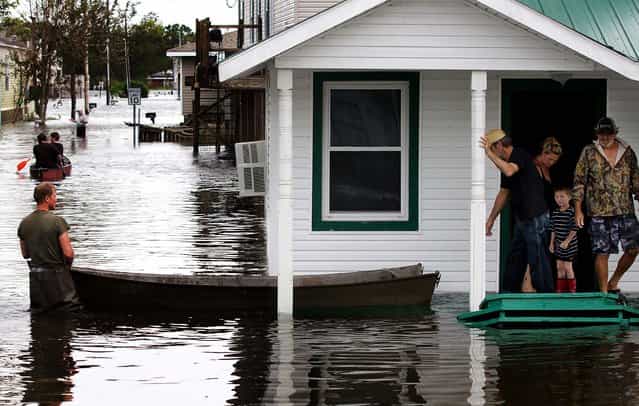 Flooding in Lafitte, Louisiana causes residents to travel by boat on Thursday. (Photo by Erik Schelzig/Associated Press)
