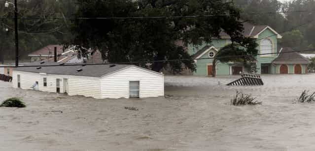 Homes are flooded as Hurricane Isaac hits Braithwaite, Louisiana. Photo by David J. Phillip/Associated Press)