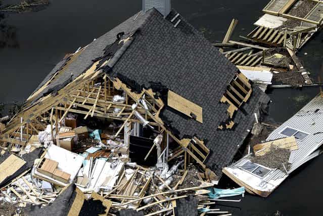 A home sits destroyed by Isaac in Yscloskey, Louisiana on Friday. (Photo by David J. Phillip/Associated Press)
