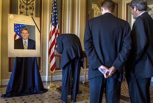 Duncan Currie signs a condolence book for J. Christopher Stevens, U.S. Ambassador to Libya, who was killed Tuesday during an attack in Behghazi, at the U.S. Capitol in Washington. (Photo by Brendan Hoffman/The New York Times)
