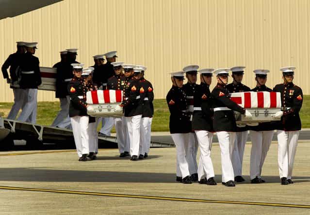Transfer cases are carried into a hangar during the Transfer of Remains Ceremony marking the return to the United States of the remains of the four Americans killed this week in Benghazi, Libya, at Joint Base Andrews. (Photo by Molly Riley/Polaris via Abaca Press/MCT)