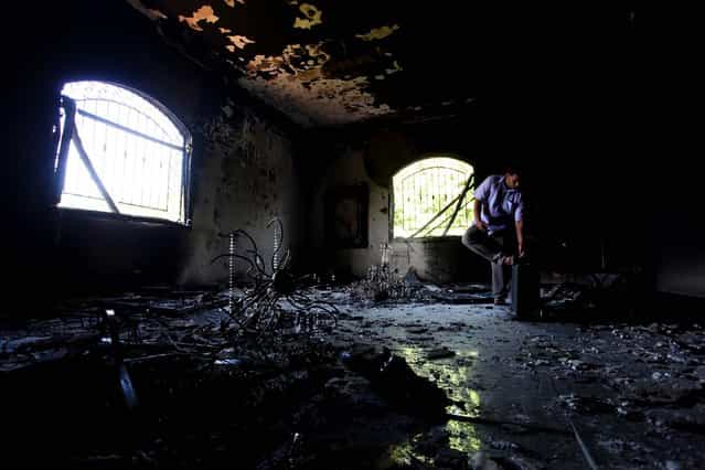 A man investigates the inside of the U.S. Consulate in Benghazi on Thursday. (Photo by Mohammad Hannon/Associated Press)