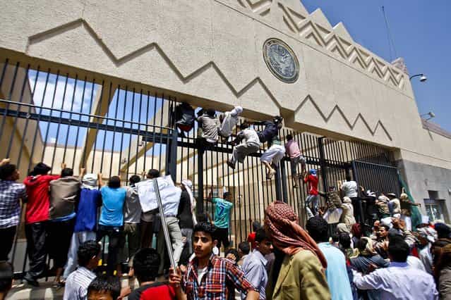 Protesters storm the gate of the U.S. Embassy in Sanaa, Yemen on Thursday. (Photo by Hani Mohammed/Associated Press)